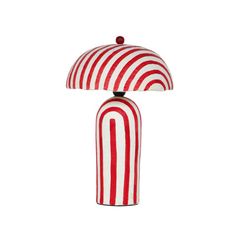 a red and white striped lamp on a white background