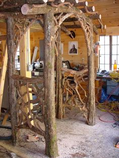 a wooden structure made out of branches in a room