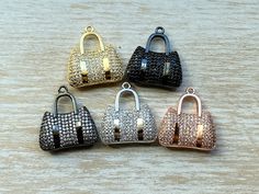 These CZ Micro Pave Purse charms would be a great addition to any DIY project. The Bling and the Sparkle will make this piece a definite standout. The charms come in 5 different colors: Silver, Gold, Rose Gold, Black & Black and Silver. Pricing is for 1 charm Size: 26mmx25mm **I do try my best to represent the actual colors of the charms but colors may slightly vary due to lighting on computer monitors or mobile devices. Charm Bracelet Charms, Bling Purses, Money Art, Beautiful Museum, Necklace Charms, Charms Necklace, Charms Bracelet, Bracelet Charms, Handbag Charms