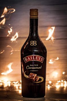 a bottle of bailey's salted caramel with sparklers in the background