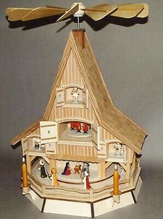 a paper model of a house with two fans on the roof and an attic above it