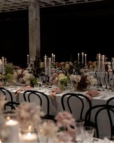 the tables are set with candles and flowers