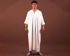 Elevate your style with our exquisite collection of men's kaftans, blending timeless elegance with modern sophistication. Crafted from luxurious fabrics, our kaftans offer the perfect fusion of comfort and refinement. Whether you're attending a cultural event or enjoying a beachside getaway, our versatile kaftans are designed to make a lasting impression.