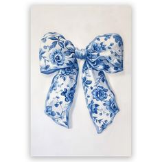 a blue and white flowered bow on a white background with clipping for text