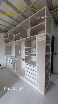 an empty room with shelves and drawers labeled in white letters that read warceso, warceso, warceso