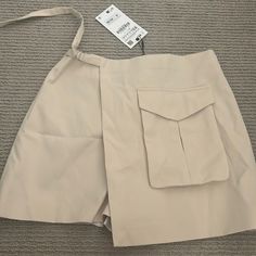 Brand New Zara Skort With Tags, Never Been Worn! Cream Color And Xs Size, Fits True To Size. You Can Tighten The Waist With The Attached Belt Summer Beige Skort With Pockets, Beige Skort With Pockets For Summer, Beige Summer Skort For Workwear, Trendy Summer Skort With Side Pockets, Khaki Skort With Pockets For Summer, Chic Zara Skort With Pockets, Spring Skort With Side Pockets For Day Out, Zara Summer Skort With Pockets, Fitted Beige Zara Shorts