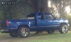 a blue pick up truck parked in the grass