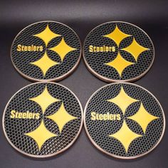 four pittsburgh steeles coasters with the word'stealrs'written on them