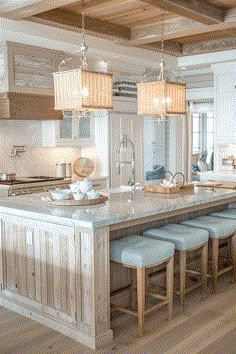 a large kitchen island with four stools in front of it and an open floor plan