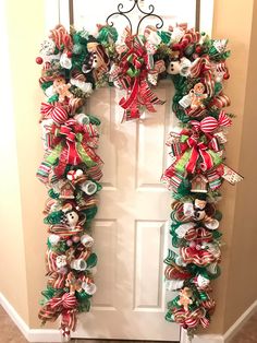 a christmas wreath hanging on the front door