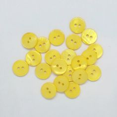 several yellow buttons on a white surface