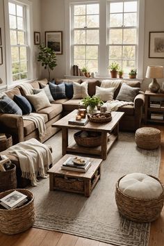 a living room filled with lots of furniture and pillows on top of a wooden floor