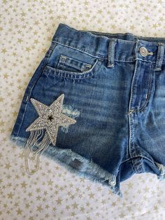 Yeehaw! The perfect denim shorts for summer are here! Beautiful star rhinestone tassel patches adorn the front and back of these shorts. Perfect paired with cowboy boots and a crop like our Bardot tee. Measurement chart is provided in photos. California Cowgirl, Shorts For Summer, Perfect Denim, Summer Is Here, Measurement Chart, Summer Shorts, Summer Collection, Cowboy Boots, Perfect Pair