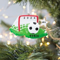 a soccer ornament hanging from a christmas tree