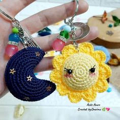 a crocheted keychain with a sun and moon charm hanging from it