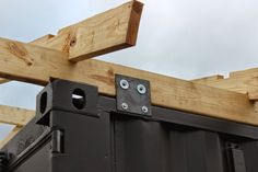 a close up view of the top of a wooden structure with metal rivets