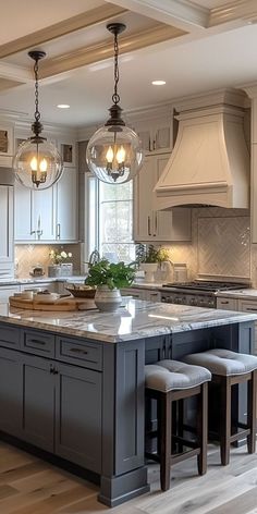 a large kitchen with an island in the middle and two stools next to it