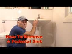 a man in blue shirt and cap holding up a sink with the words how to remove a pedestal sink