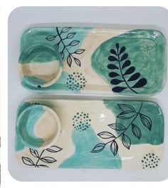 two ceramic dishes with painted leaves on them