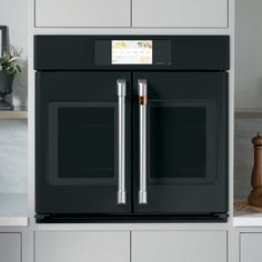 a black oven with the door open and two silver handles on it's side