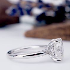 a diamond ring sitting on top of a table