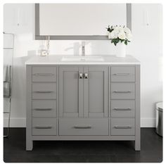 a bathroom vanity with drawers and a mirror