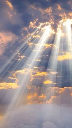 the sun is shining through clouds with bright rays coming from behind it in the sky