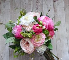 a bouquet of flowers sitting on top of a wooden table