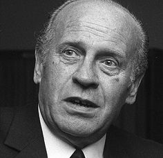 black and white photograph of an older man in a suit with a surprised look on his face