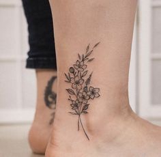 a small flower tattoo on the ankle