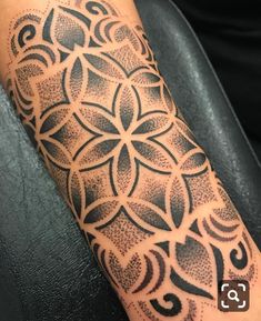 a person with a tattoo on their arm that has an intricate design in the middle