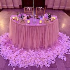 the table is set up with flowers and candles