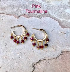 14K gold plated Hoop-looking earrings that are worn like any earring with a post. Earrings are 22mm in diameter which is neither too small nor too big for everyday wear. All Natural semiprecious stone beads. Pictures show pink Tourmaline and Lapis Lazuli stone earrings. There are more stone choices in options to choose from. If you have any specific stone in mind please reach out to me and I may be able to accommodate. Gold Earrings With Gemstone Beads, Beads Pictures, Lapis Lazuli Stone, Tourmaline Beads, Beaded Hoop Earrings, Stone Earrings, Pink Tourmaline, Stone Beads, Lapis Lazuli