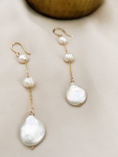 These are perfect for wear every day, with our 3 Pearl dangle earrings you are elegant with them. Is fashionable at any time. If you like simple, classy, and Unique jewelry, these earrings are perfect for you. They make elegant, versatile earrings. Details: - material: 14k gold-filled 14k rose gold-filled sterling silver - measure: 3 inches - Gems: freshwater round pearl and coin pearl (free-form) ADDITIONAL INFORMATION These earrings have been created by hand so no two pieces are identical. Eac