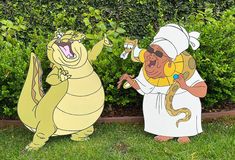 two cartoon characters are standing in the grass