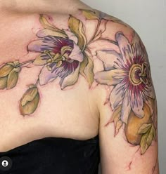 a woman's shoulder with flowers painted on it