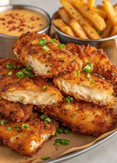 fried chicken and french fries on a plate with dipping sauce