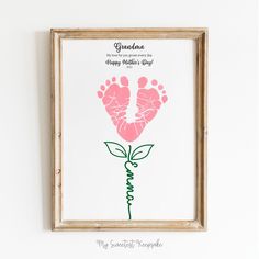 a baby's hand and foot prints are displayed in a frame on the wall