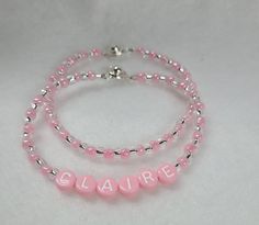 Listing is for ONE bracelet, your choice of name bracelet or plain. Order 1 of each to stack.  Sweet pink personalized bracelet.  Handmade to order using 4 mm alpha plastic bead,  pink and clear silver lined 6/0 size seed glass beads and wire strung with button clasp.  Clasp is easy use, just press top button to open and close.    Please double check name spelling and wrist size using a measuring tape, add 1/2 inch for snug fit, add 1 inch for loose fit.  Nicely packaged, Bracelet will be placed Bracelet Name, Friendship Bracelets With Beads, Gift Bracelet, Tooth Fairy Pillow, Bracelet Friendship, Personalized Bracelet, Bracelet Diy, Silver Line, Name Bracelet