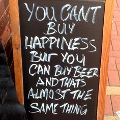 a sign that says you can't buy happiness but you can buy beer and hate the same thing