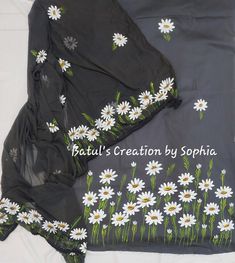 a black dress with white daisies on it