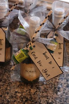 wine bottles wrapped in clear cellophane and tied with twine ribbons, sitting on a granite countertop