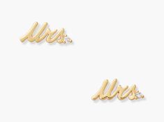 two pairs of gold earrings with the word mrs on them and diamonds in each ear