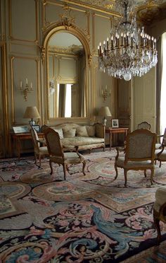 an ornately decorated living room with chandelier