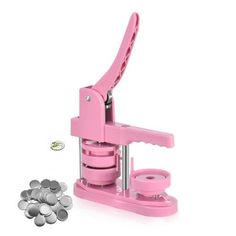 a pink machine that is next to some silver coins