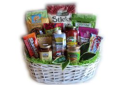 a white basket filled with lots of food and condiments on top of green grass