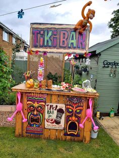 an outdoor tiki bar decorated with decorations