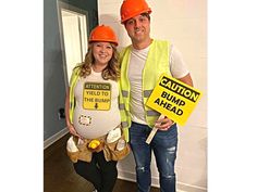 a man and woman dressed in construction gear posing for the camera with caution signs on their bodies