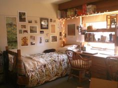 a bedroom with pictures on the wall and a bed in front of a computer desk