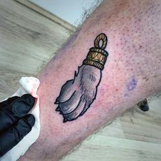 a hand with a crown tattoo on it